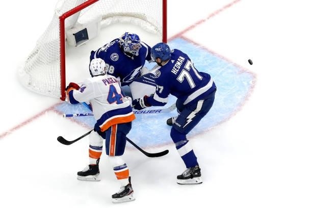 Andrei Vasilevskiy of the Tampa Bay Lightning makes the save against Jean-Gabriel Pageau of the New York Islanders as Victor Hedman defends during...