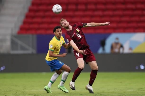 Marquinhos of Brazil competes for the ball with Fernando Aristeguieta of Venezuela during a Group B match between Brazil and Venezuela as part of...
