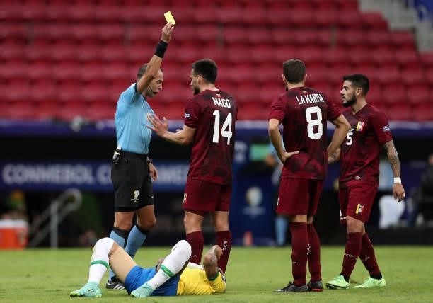 Referee Esteban Ostojich shows a yellow card to Luis Mago of Venezuela during a Group B match between Brazil and Venezuela as part of Copa America...