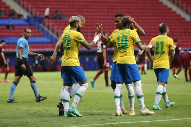 Gabriel Barbosa of Brazil celebrates with teammates after scoring the third goal of his team during a Group B match between Brazil and Venezuela as...