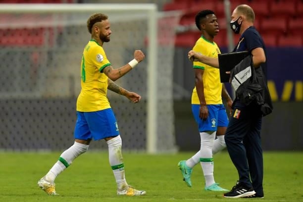 Neymar Jr. Of Brazil bumps fists with an assistant coach of Venezuela during a Group B match between Brazil and Venezuela as part of Copa America...