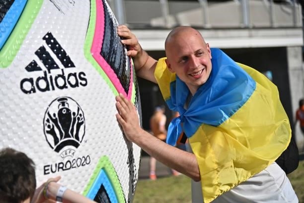 Fans of Ukraine poses near a Adidas Uniforia official ball installation prior the UEFA Euro 2020 Championship Group C match between Netherlands and...