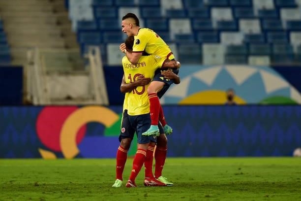 Edwin Cardona of Colombia celebrates with teammates Rafael Santos Borre and Miguel Borja after scoring the first goal of his team during a Group B...
