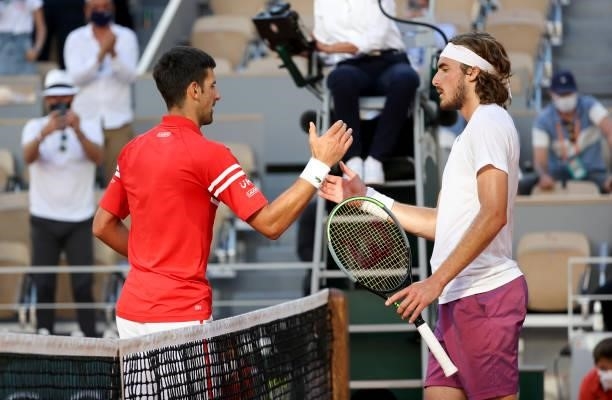 Winner Novak Djokovic of Serbia shakes hands with Stefanos Tsitsipas of Greece following the Men's Singles final on day 15 of the French Open 2021,...