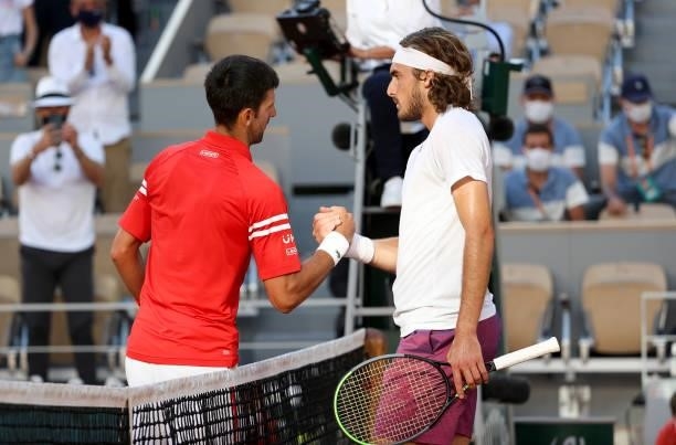 Winner Novak Djokovic of Serbia shakes hands with Stefanos Tsitsipas of Greece following the Men's Singles final on day 15 of the French Open 2021,...