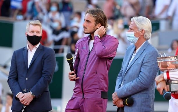 Finalist Stefanos Tsitsipas of Greece between Jim Courier, Bjorn Borg during the trophy ceremony for the Men's Singles final on day 15 of the French...