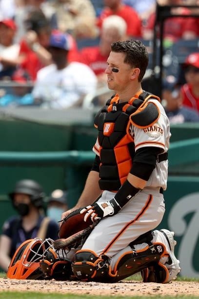 Catcher Buster Posey of the San Francisco Giants looks on against the Washington Nationals at Nationals Park on June 13, 2021 in Washington, DC.