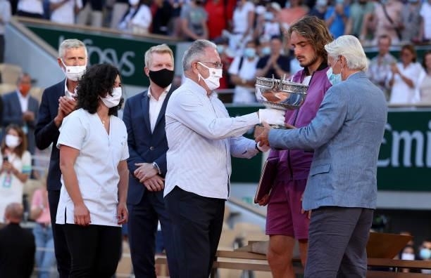 Medical workers who are fighting the pandemic carry the trophy to Bjorn Borg while President of French Tennis Federation FFT Gilles Moretton, Jim...