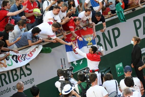 Novak Djokovic of Serbia thanks the fans of Serbia following his victory in the Men's Singles final on day 15 of the French Open 2021, Roland-Garros...