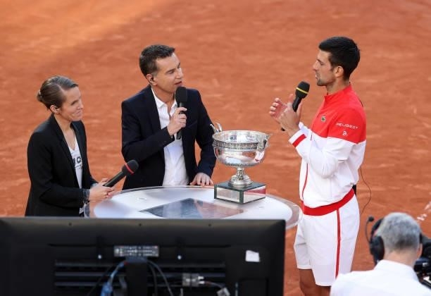 Novak Djokovic of Serbia is interviewed by Justine Henin and Laurent Luyat of France Televisions following his victory in the Men's Singles final on...