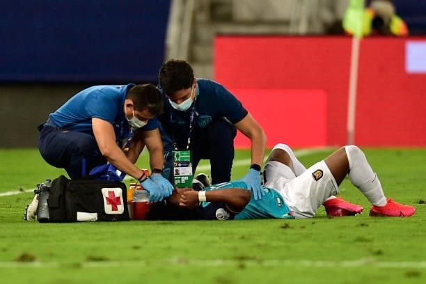 Angelo Preciado of Ecuador receives medical attention after being injured during a Group B match between Ecuador and Colombia at Arena Pantanal on...