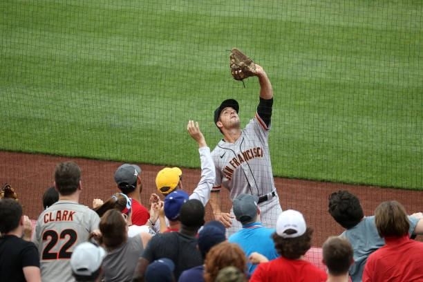 Jason Vosler of the San Francisco Giants makes a catch in foul territory against the Washington Nationals at Nationals Park on June 13, 2021 in...