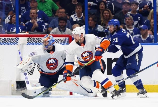 Scott Mayfield and Semyon Varlamov of the New York Islanders defend against Anthony Cirelli of the Tampa Bay Lightning in Game One of the Stanley Cup...