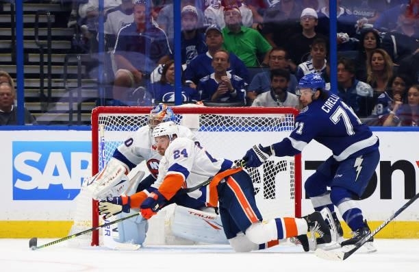 Scott Mayfield and Semyon Varlamov of the New York Islanders defend against Anthony Cirelli of the Tampa Bay Lightning in Game One of the Stanley Cup...