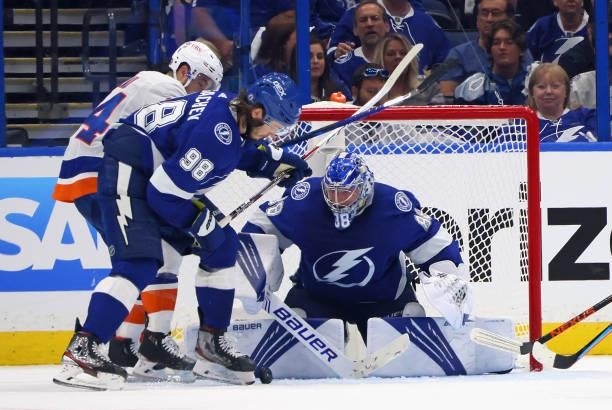 Mikhail Sergachev and Andrei Vasilevskiy of the Tampa Bay Lightning defend against Jean-Gabriel Pageau of the New York Islanders in Game One of the...