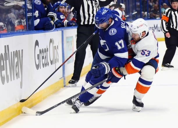 Alex Killorn of the Tampa Bay Lightning is checked by Casey Cizikas of the New York Islanders in Game One of the Stanley Cup Semifinals during the...