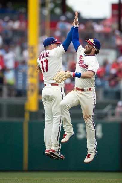 Rhys Hoskins of the Philadelphia Phillies high fives Bryce Harper after the game against the New York Yankees at Citizens Bank Park on June 13, 2021...