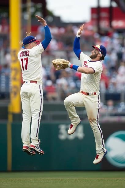 Rhys Hoskins of the Philadelphia Phillies high fives Bryce Harper after the game against the New York Yankees at Citizens Bank Park on June 13, 2021...