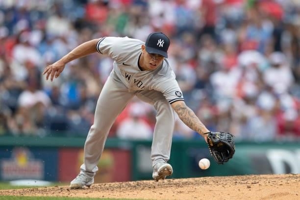 Jonathan Loaisiga of the New York Yankees reaches for the ball against the Philadelphia Phillies at Citizens Bank Park on June 13, 2021 in...