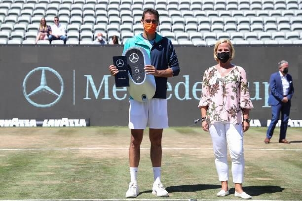 Marin Cilic of Croatia poses with trophy next to Britta Seeger, Member of Mercedes-Benz board for distribution after Men`s single final match during...