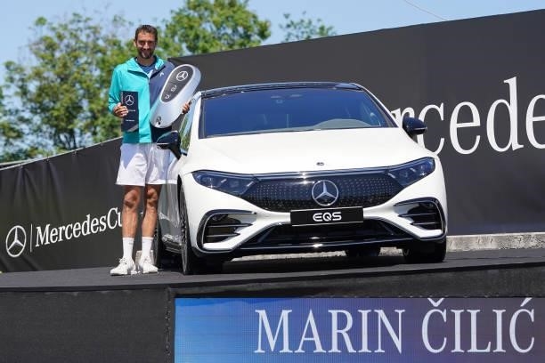 Marin Cilic of Croatia poses with trophy next to Mercedes-Benz winner`s car after Men`s final match during day 7 of the MercedesCup at Tennisclub...
