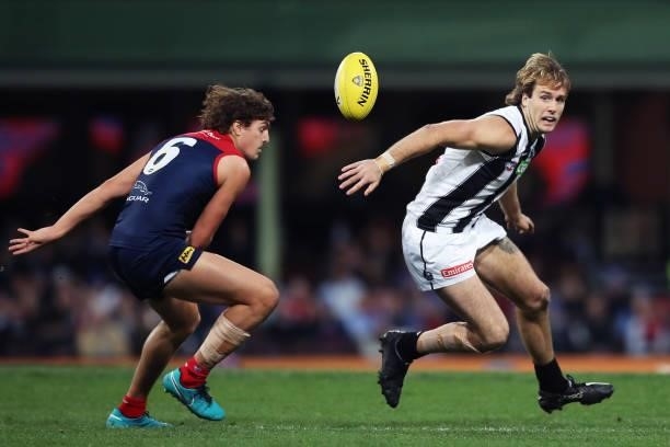 Max Lynch of the Magpies competes for the ball against Luke Jackson of the Demons during the round 13 AFL match between the Melbourne Demons and the...