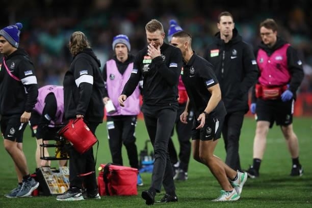 Magpies head coach Nathan Buckley walks back to the coaches box after speaking to his players at three quarter time during the round 13 AFL match...