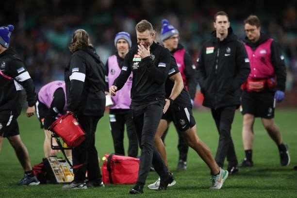 Magpies head coach Nathan Buckley walks back to the coaches box after speaking to his players at three quarter time during the round 13 AFL match...