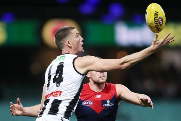 Darcy Cameron of the Magpies takes a controversial mark over Steven May of the Demons during the round 13 AFL match between the Melbourne Demons and...