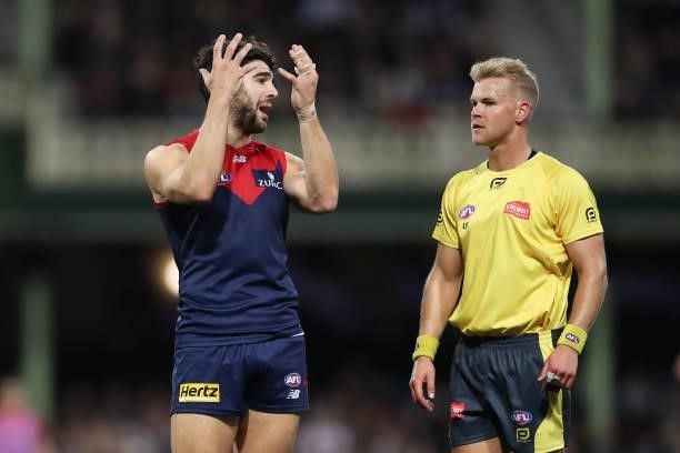 Christian Petracca of the Demons argues with an umpire after Darcy Cameron of the Magpies took a controversial mark over Steven May of the Demons...