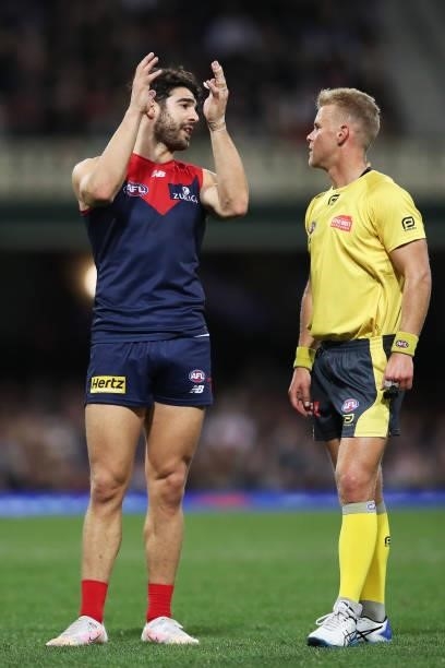 Christian Petracca of the Demons argues with an umpire after Darcy Cameron of the Magpies took a controversial mark over Steven May of the Demons...