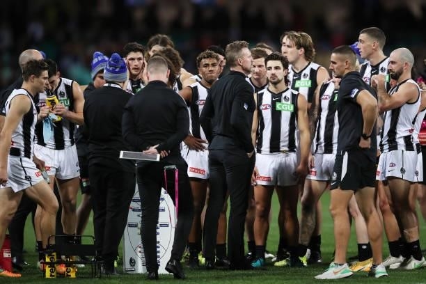 Magpies head coach Nathan Buckley speaks to players at three quarter time during the round 13 AFL match between the Melbourne Demons and the...