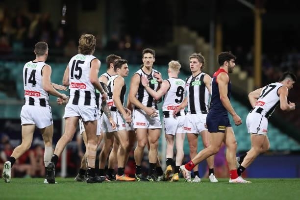 Brody Mihocek of the Magpies celebrates with team mates after kicking a goal during the round 13 AFL match between the Melbourne Demons and the...