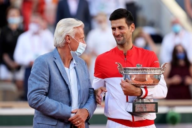 Novak Djokovic of Serbia stands with former tennis player Bjorn Borg as receives the trophy after winning his Men's Singles Final match against...