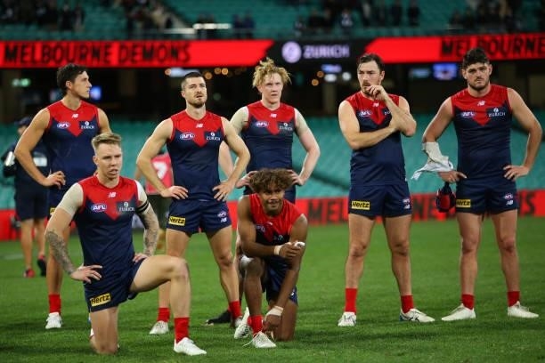 Demons players look dejected during the round 13 AFL match between the Melbourne Demons and the Collingwood Magpies at Sydney Cricket Ground on June...