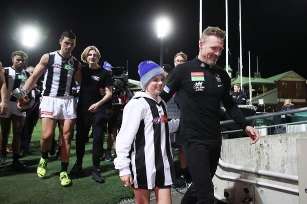 Magpies head coach Nathan Buckley celebrates victory with son Ayce Buckley after coaching his final game for the Magpies during the round 13 AFL...