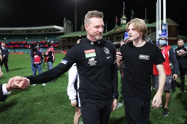 Magpies head coach Nathan Buckley celebrates victory with son Jett Buckley after coaching his final game for the Magpies during the round 13 AFL...