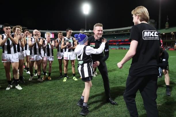 Magpies head coach Nathan Buckley celebrates victory with sons Ayce Buckley and Jett Buckley after coaching his final game for the Magpies during the...