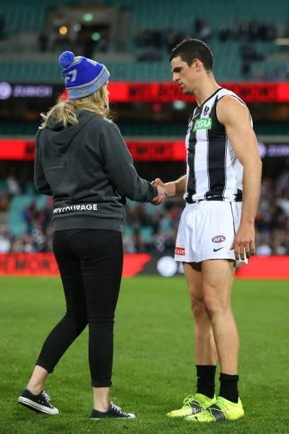 Scott Pendlebury of the Magpies is presented the Neale Daniher Trophy during the round 13 AFL match between the Melbourne Demons and the Collingwood...