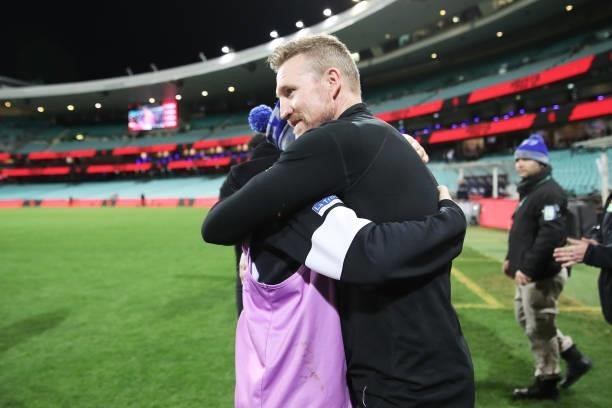 Magpies head coach Nathan Buckley celebrates victory with Magpies staff after coaching his final match for the Magpies during the round 13 AFL match...
