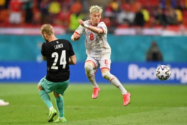 Egzijan Alioski of North Macedonia is challenged by Konrad Laimer of Austria during the UEFA Euro 2020 Championship Group C match between Austria and...