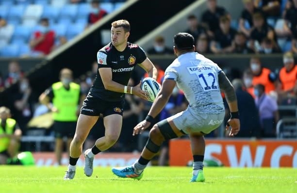 Ollie Devoto of Exeter Chiefs takes on Manu Tuilagi of Sale Sharks during the Gallagher Premiership Rugby match between Exeter Chiefs and Sale at...