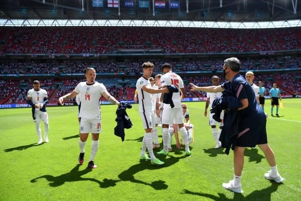 Kalvin Phillips and John Stones of England remove their tops before the UEFA Euro 2020 Championship Group D match between England and Croatia on June...