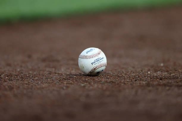 Detailed view of a a Major League Baseball ball in the dirt is seen at Nationals Park on June 11, 2021 in Washington, DC.