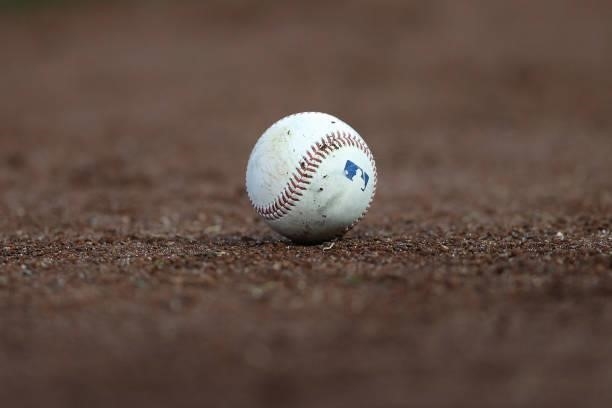 Detailed view of a a Major League Baseball ball in the dirt is seen at Nationals Park on June 11, 2021 in Washington, DC.