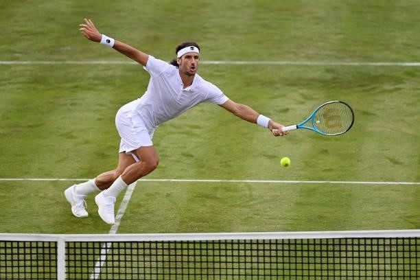 Feliciano Lopez of Spain stretches to play a forehand in his First Round match against Illya Marchenko of Ukraine during Day 1 of the cinch...