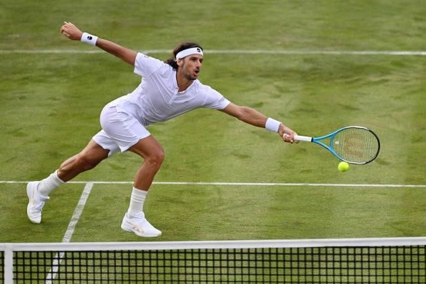 Feliciano Lopez of Spain stretches to play a forehand in his First Round match against Illya Marchenko of Ukraine during Day 1 of the cinch...