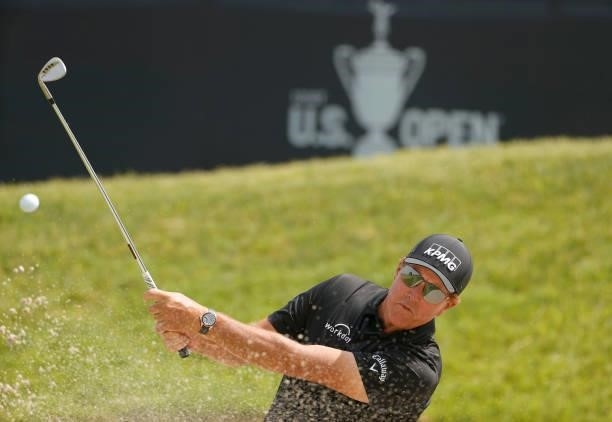 Phil Mickelson of the United States plays a shot from a bunker on the 13th hole during a practice round prior to the start of the 2021 U.S. Open at...