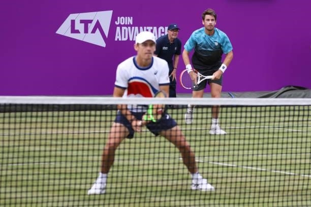 Cameron Norrie of Great Britain, playing partner of Alex de Minaur of Australia serves in their First Round Doubles match against Andrea Vavassori...