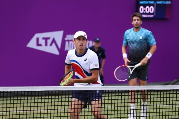 Alex de Minaur of Australia, playing partner of Cameron Norrie of Great Britain prepares to return the ball in their First Round Doubles match...